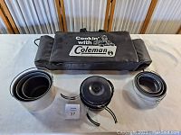 Coleman cook set pots and pans with black carrying case labeled 'Cookin with Coleman'