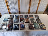 Photo of 22 DVD cases laid out on a table showing various sci-fi, thriller, horror, and fantasy movies