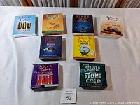 Front view of all 8 boxed unabridged Robert B. Parker CD audiobook sets arranged on a table showing title and cover graphics.