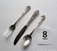 Three-piece silverplate set including a fork, knife, and spoon laid out for size comparison.