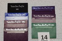 Full view of all seven original envelopes for U.S. proof sets from 1982, 1983, 1984, 1989, 1992, 1993, and 1994