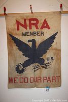 Full front view of the 1933 NRA cotton flag bunting showing 'NRA MEMBER', eagle graphic, and 'WE DO OUR PART' slogan.