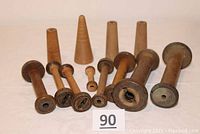 All 12 wooden industrial bobbins, spools, and spindles displayed showing different sizes and styles