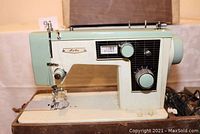 Front view of the Lits Model 290F two-tone green sewing machine, showing cream and mint green colors, dials, and sewing area