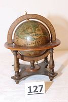 Wooden terrestrial globe with zodiac ring and tripod wooden base shown front view