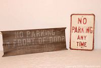 Photo showing both the wooden and metal no parking signs side by side, providing a full view of both items.