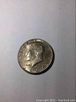 Front side of the 1964 Kennedy Half Dollar showcasing JFK profile and date.