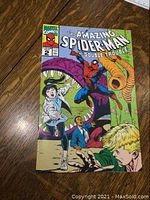 Front cover of The Amazing Spider-Man Double Trouble Vol. 1 No. 2 comic showing Spider-Man and other characters in colorful action scene, laying on wooden surface.