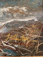 Close up photo of the artist's signature in yellow paint on the lower portion of the winter cabin painting.