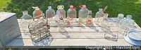 All milk bottles laid out on a table, showing various bottle sizes, milk case, and modern bottle set.