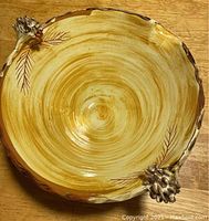 Top view of large Vallauris bowl showing bark-painted interior and pine cone style handles.