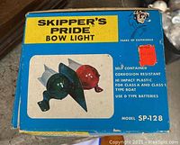 Original box for Skipper's Pride bow lights showing front with product image and text describing corrosion resistance and battery type.