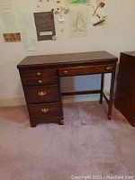 Full view of wooden Carolina Furniture desk showing the drawers and general condition.