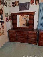 Front view of the dresser with mirror and side shelves, showing all drawers and the overall structure.