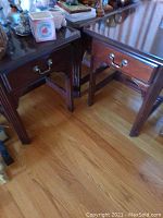 Two wooden Kincaid end tables shown side by side, both have single drawer with brass handles and dark brown finish.