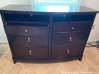 Front view of the Kincaid dresser showing six drawers with metal ring pulls and two open shelves above the drawers.