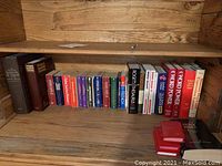 Books on lower wooden shelf showing thick tomes like Roget's Thesaurus, Word Power, and various language and reference books