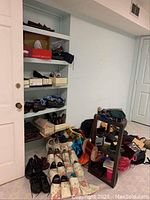 Photo showing shelves filled with men's and women's shoes, some shoes outside on the floor, bags next to them.