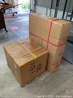 Two cardboard boxes packed and strapped, containing the filing cabinet hidden safe.