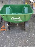 Green Scotts Model 1000 spreader on asphalt surface