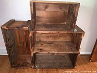 Four wooden farmhouse crates stacked and arranged showing size and condition.