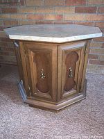 Octagonal table with wooden cabinet base showing front and removable marble top