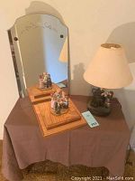 Photo showing the mirror, wooden stand with Norman Rockwell statue, and Norman Rockwell lamp with figurine base and lampshade