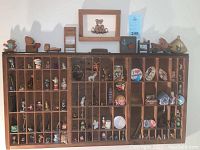 Full view of wooden printer's box filled with various miniatures and collectibles