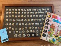 Framed display of 100 Kellogg Pep pinback buttons on black felt backing