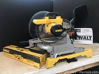 Front perspective showing saw base, blade, manual, and mounting bracket box