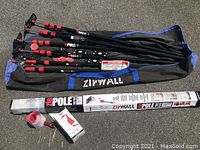 All poles with carry bag, adhesive zipper, flap hooks, and packaged poles shown on pavement