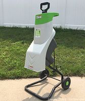 Front-side view of the Chicago Electric chipper shredder showing white and green housing, handle, hopper, and wheels on black frame.