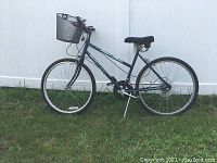 Full side view of the blue Rock Creek Free Spirit All Terrain women's bicycle showing frame, wheels, seat, basket, and kickstand.