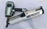 Full view of Hitachi NR90AE(S1) framing nailer showing metal body, magazine, and rubber grip handle.