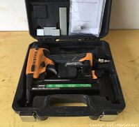 Bostitch SX1838 pneumatic staple fastener with staples and instruction manual inside black hard plastic carrying case.