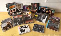 Overview of various music CDs and DVDs and TV series DVDs in the lot