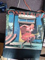 Front cover of the vinyl record album She's So Unusual by Cyndi Lauper showing the artist in pink and the album title.