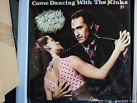 Front cover of the vinyl record album 'Come Dancing with The Kinks - The Best of the Kinks 1971-1986', showing a man and woman dancing, with the album title and gold sticker.
