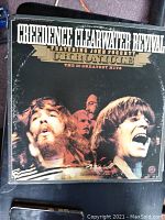 Front cover of Creedence Clearwater Revival vinyl album titled 'Chronicle-The 20 Greatest Hits' showing band members and record label name.