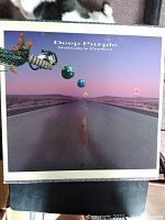 Cover of Deep Purple "Nobody's Perfect" vinyl album showing surreal road image with marbles and glove.