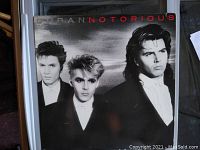 Front cover of Duran Duran's 1986 Notorious album on Tritec Records, showcasing band members with red album title lettering.