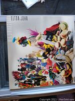 Front cover of the vinyl record album showing artistic colorful figures and text with artist and album name.