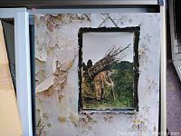 Framed Led Zeppelin IV album cover art print with peeling wall texture background.