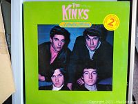 Front cover of 'The Kinks - A Complete Collection' vinyl album with band photo and green background.