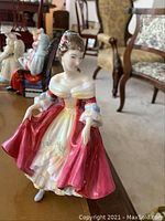 Photo of the Royal Doulton Southern Belle figurine showing details of the red gown and facial features.
