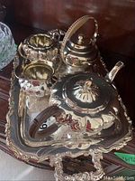Full view of the hand chased silverplate tea set and the tray showing all pieces and ornate details.