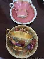 Overview of both tea cups and saucers showing patterns