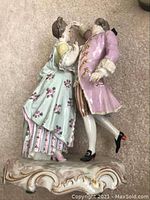Front view of Meissen porcelain dancing couple figurine on scroll-shaped base
