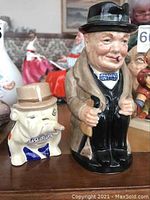Front view of Winston Churchill character jug and bulldog figurine side by side