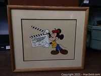 Frontal image of the framed cel painting showing Mickey Mouse holding a clapperboard.